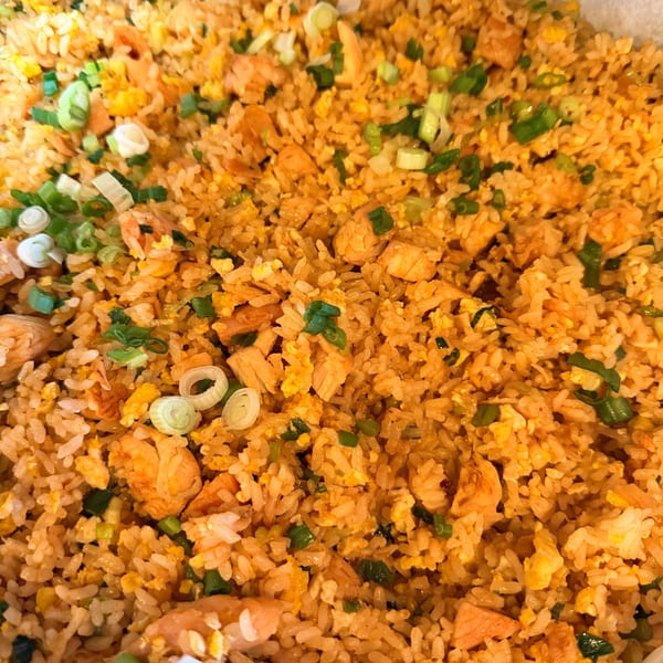 Close-up of Angry Chicken's fried rice with chicken, scrambled egg, and green onions.