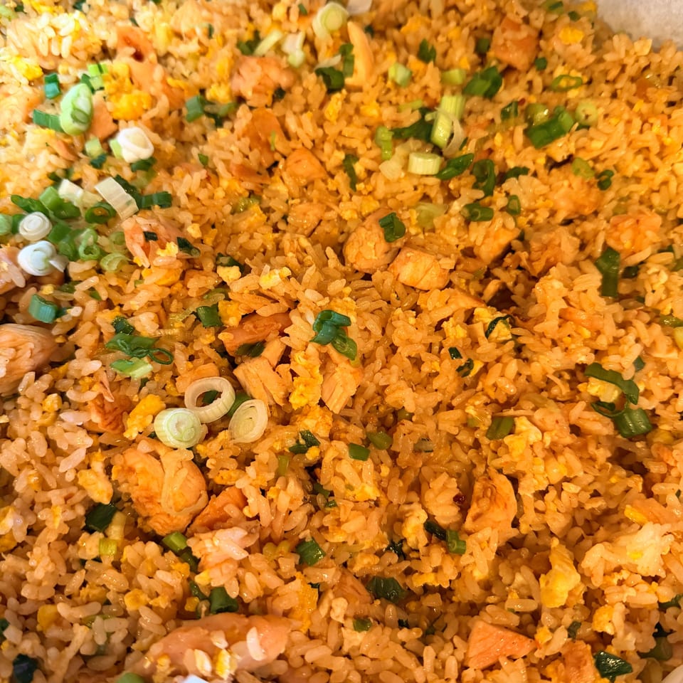 Close-up of Angry Chicken's fried rice with chicken, scrambled egg, and green onions.